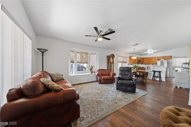 living area with ceiling fan, lofted ceiling, dark wood-style floors, and visible vents