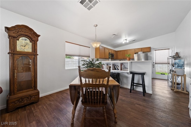 dining area with visible vents, dark wood finished floors, baseboards, and vaulted ceiling