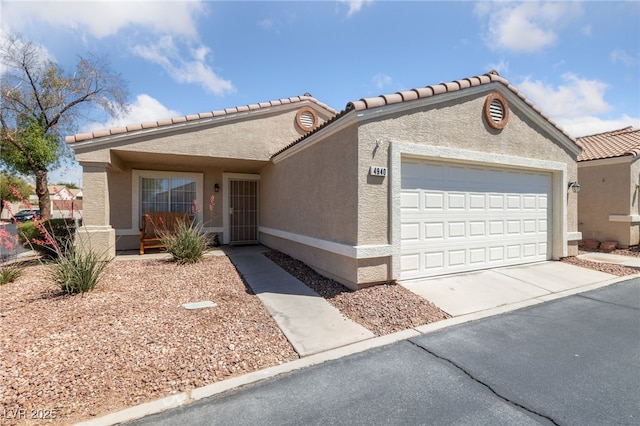 view of front of house featuring concrete driveway, an attached garage, and stucco siding
