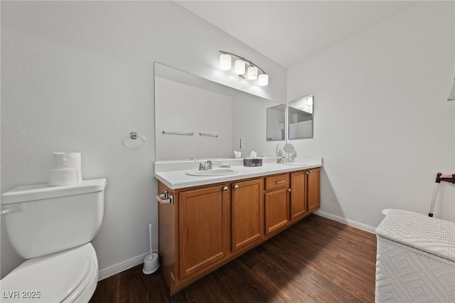 full bathroom with baseboards, a sink, and toilet