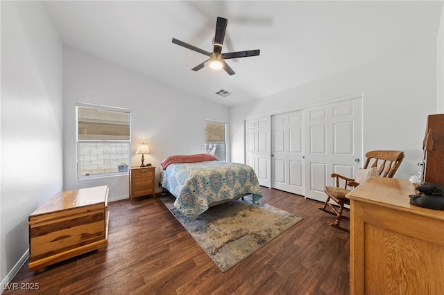 bedroom featuring visible vents, vaulted ceiling, baseboards, a closet, and dark wood-type flooring