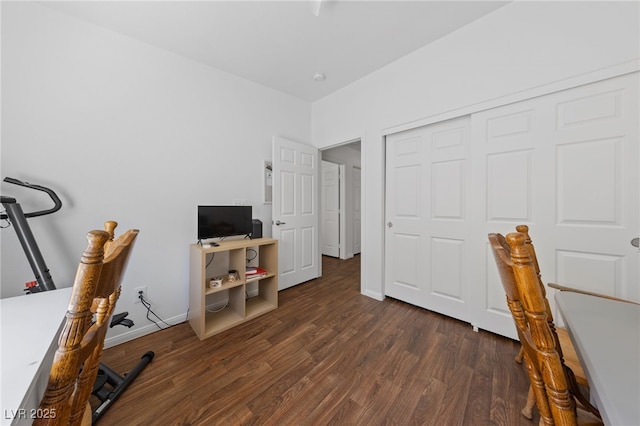 interior space featuring baseboards and dark wood-style floors