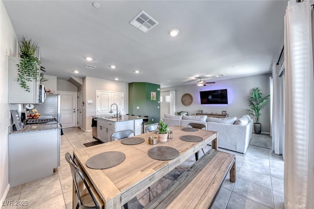 dining room with light tile patterned flooring, ceiling fan, recessed lighting, baseboards, and visible vents
