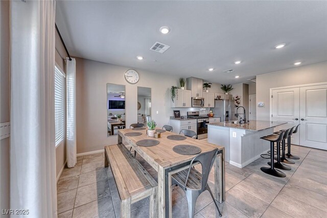 dining space featuring visible vents, recessed lighting, baseboards, and light tile patterned flooring