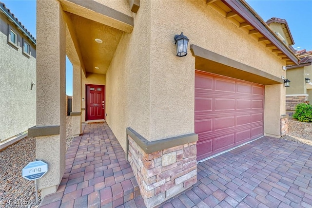 view of exterior entry with stucco siding