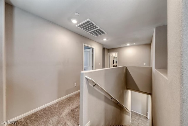 corridor featuring visible vents, carpet floors, baseboards, an upstairs landing, and recessed lighting