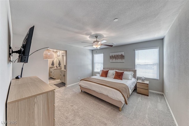 bedroom featuring visible vents, a ceiling fan, a textured ceiling, and light colored carpet
