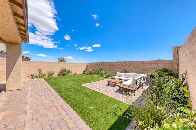view of yard featuring a patio, an outdoor living space, and a fenced backyard