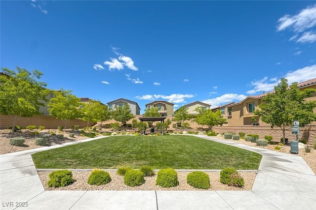 view of home's community with a residential view and a lawn