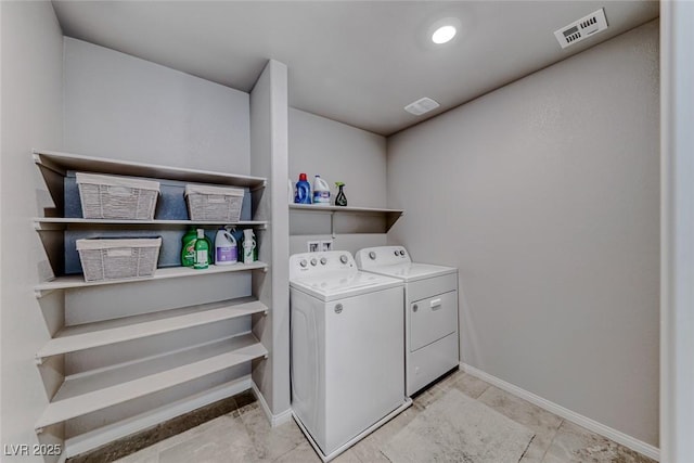 laundry room with laundry area, visible vents, washing machine and dryer, and baseboards
