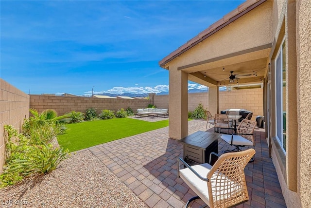 view of patio / terrace with a fenced backyard, a ceiling fan, and outdoor lounge area