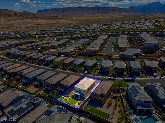 birds eye view of property with a mountain view and a residential view