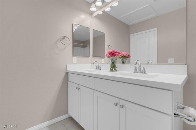 full bathroom with double vanity, a sink, baseboards, and tile patterned flooring
