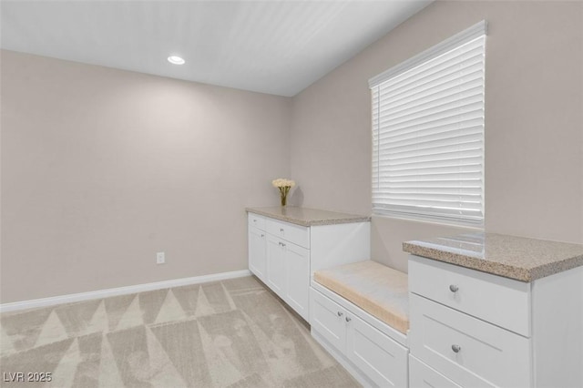 mudroom with recessed lighting, baseboards, and light colored carpet