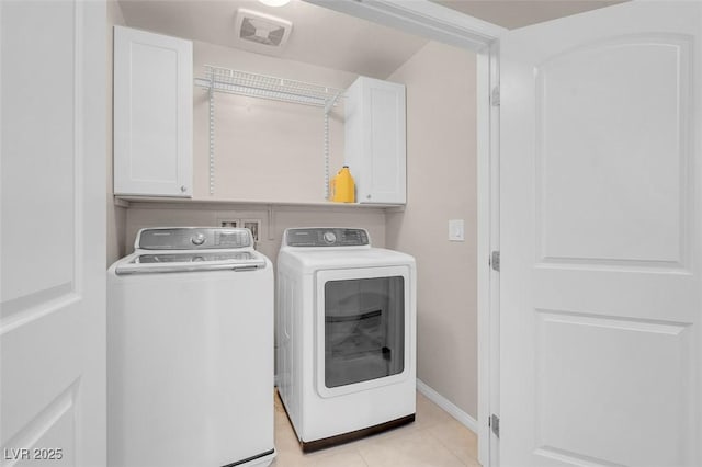 laundry room with visible vents, cabinet space, light tile patterned floors, baseboards, and washer and clothes dryer