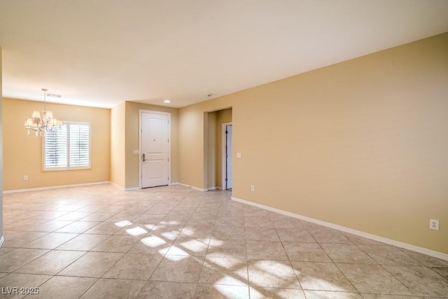 unfurnished room featuring baseboards, light tile patterned floors, and a chandelier