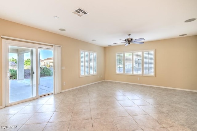 empty room featuring light tile patterned floors, baseboards, ceiling fan, and visible vents