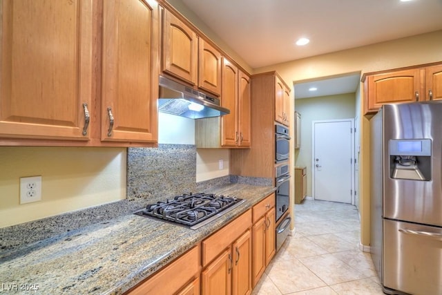 kitchen with light stone countertops, gas cooktop, recessed lighting, under cabinet range hood, and stainless steel fridge with ice dispenser
