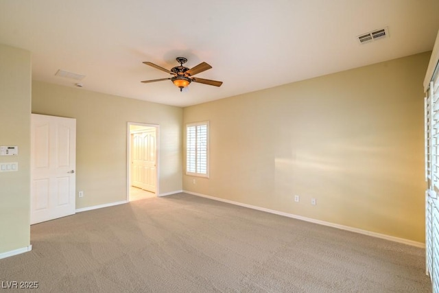 unfurnished room with baseboards, a ceiling fan, carpet flooring, and visible vents