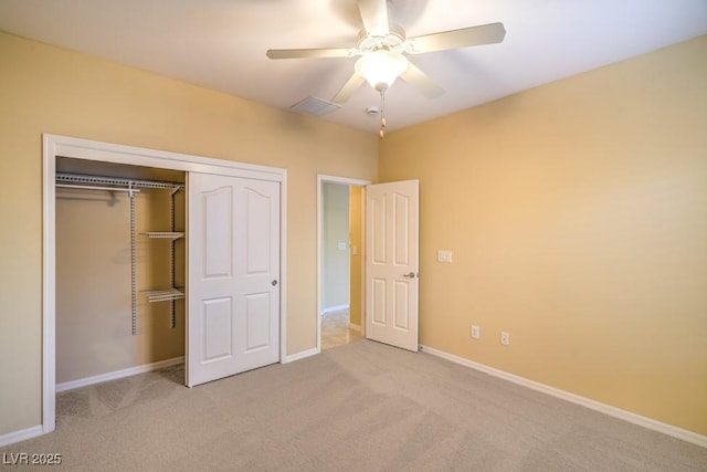 unfurnished bedroom featuring a closet, visible vents, baseboards, ceiling fan, and carpet flooring
