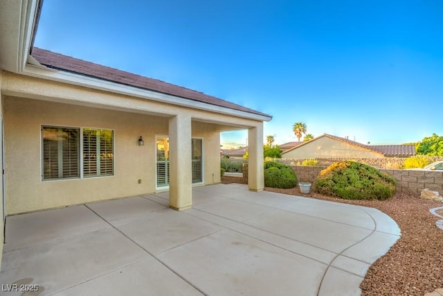 view of patio featuring fence