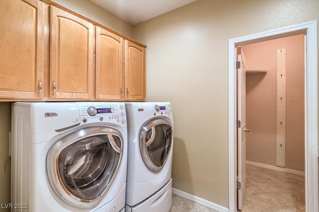 washroom with cabinet space, light tile patterned flooring, baseboards, and washer and dryer