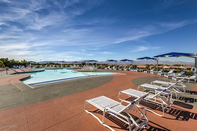 pool featuring a patio and a mountain view