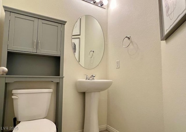 361 Andy Wheeler Dr, Henderson, NV 89011 - bathroom featuring toilet, baseboards, and a sink