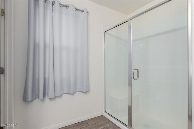 361 Andy Wheeler Dr, Henderson, NV 89011 - bathroom featuring baseboards, wood finished floors, and a stall shower