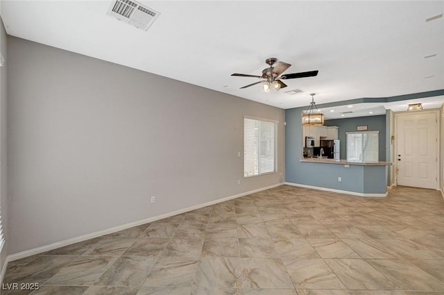 unfurnished living room with baseboards, ceiling fan, and visible vents