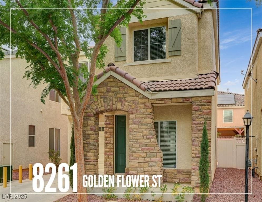 8261 Golden Flowers St, Las Vegas, NV 89139 - view of front facade with stone siding, a tiled roof, and stucco siding