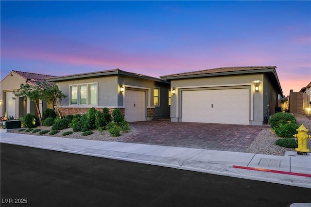 712 Webber Park St, Henderson, NV 89011 - view of front of house featuring decorative driveway, a garage, stucco siding, and a tiled roof