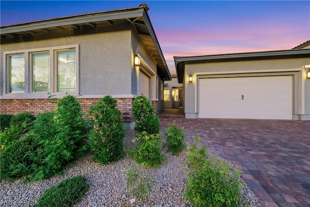 712 Webber Park St, Henderson, NV 89011 - view of front facade with a garage, stucco siding, driveway, and brick siding