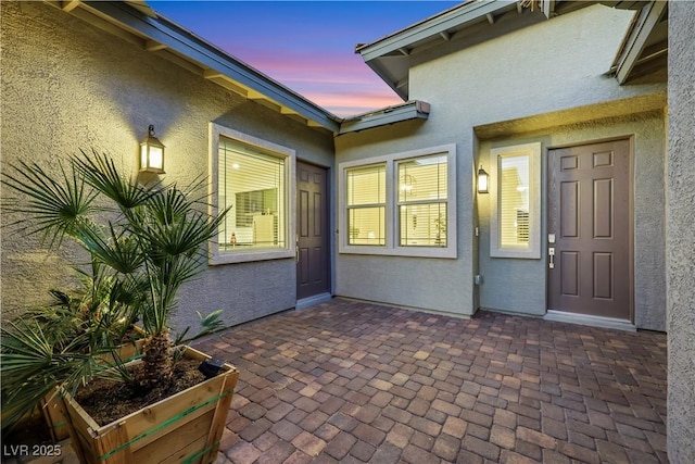 712 Webber Park St, Henderson, NV 89011 - exterior entry at dusk featuring a patio and stucco siding
