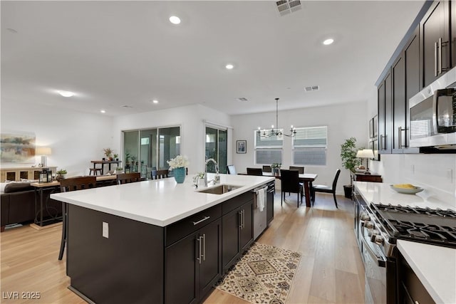 712 Webber Park St, Henderson, NV 89011 - kitchen featuring a sink, stainless steel appliances, light wood finished floors, and visible vents