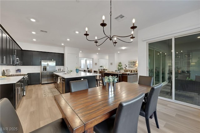712 Webber Park St, Henderson, NV 89011 - dining space with recessed lighting, a notable chandelier, light wood finished floors, and visible vents