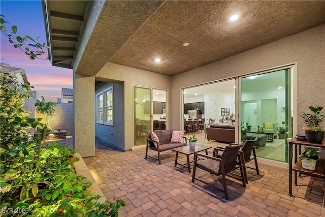 712 Webber Park St, Henderson, NV 89011 - patio terrace at dusk featuring an outdoor living space and fence