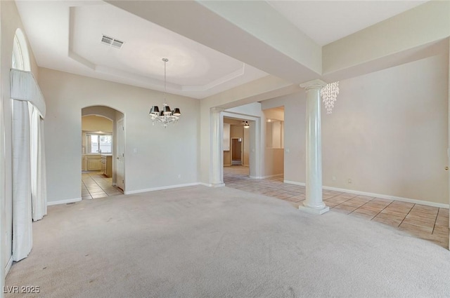 8052 Marbella Cir, Las Vegas, NV 89128 - empty room featuring arched walkways, light carpet, a chandelier, and light tile patterned floors
