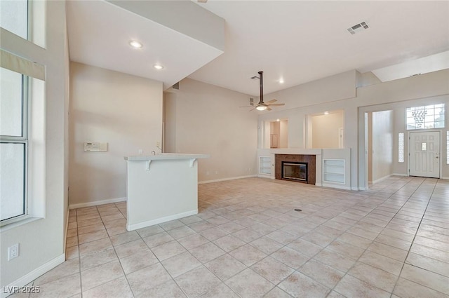 8052 Marbella Cir, Las Vegas, NV 89128 - unfurnished living room with ceiling fan, light tile patterned floors, a fireplace, baseboards, and recessed lighting