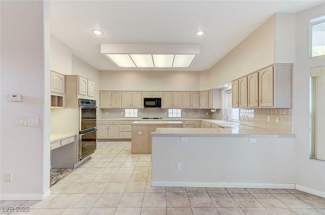 8052 Marbella Cir, Las Vegas, NV 89128 - kitchen with black appliances, light tile patterned floors, and tasteful backsplash