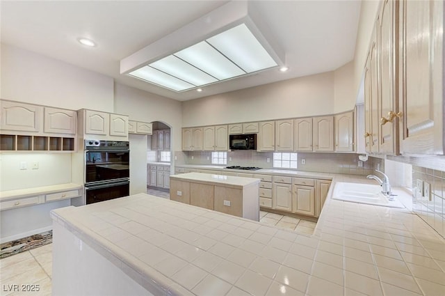 8052 Marbella Cir, Las Vegas, NV 89128 - kitchen featuring black appliances, a sink, a kitchen island, light tile patterned floors, and a towering ceiling