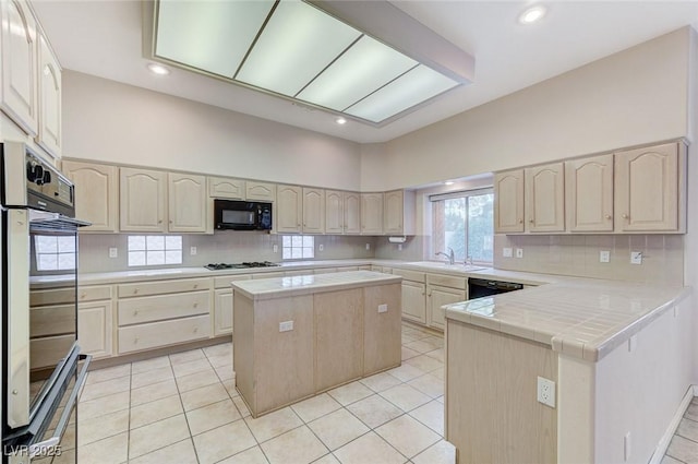 8052 Marbella Cir, Las Vegas, NV 89128 - kitchen with black microwave, tasteful backsplash, double wall oven, gas cooktop, and a kitchen island