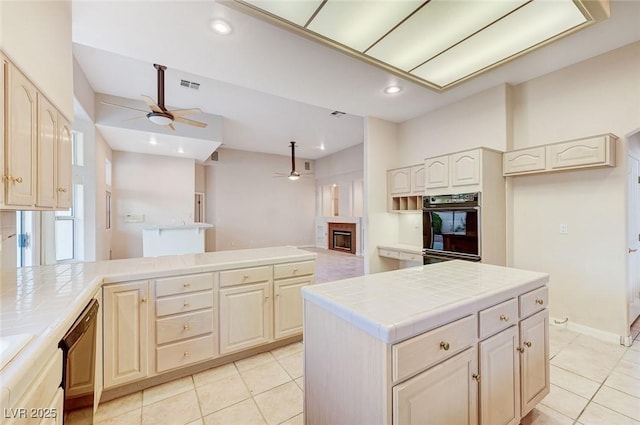 8052 Marbella Cir, Las Vegas, NV 89128 - kitchen with a ceiling fan, tile counters, light tile patterned floors, and recessed lighting