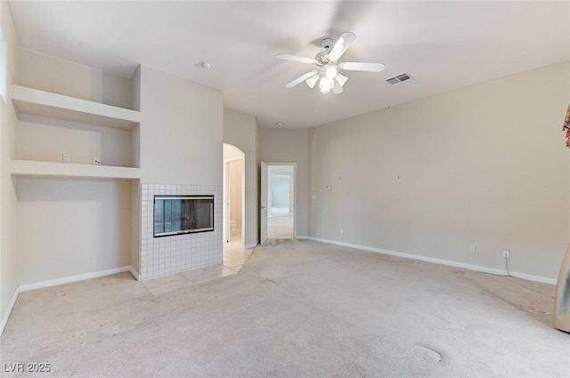 8052 Marbella Cir, Las Vegas, NV 89128 - unfurnished living room with carpet floors, a tile fireplace, baseboards, and a ceiling fan