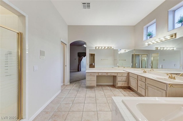 8052 Marbella Cir, Las Vegas, NV 89128 - bathroom featuring double vanity, a shower stall, a bath, tile patterned floors, and a high ceiling