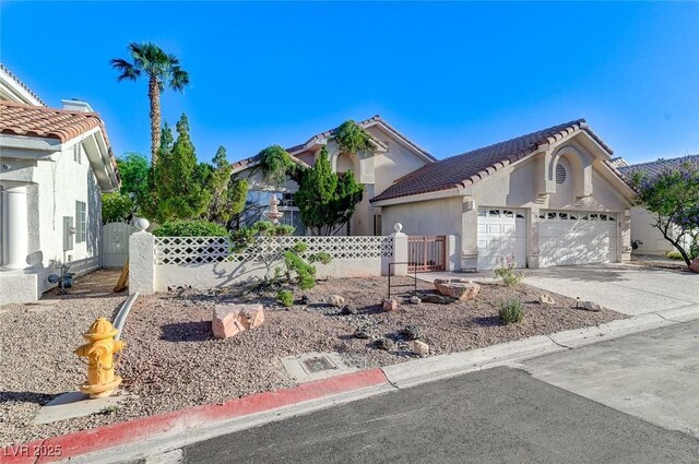 8052 Marbella Cir, Las Vegas, NV 89128 - view of front of house featuring an attached garage, driveway, a tile roof, and stucco siding