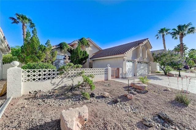 8052 Marbella Cir, Las Vegas, NV 89128 - view of front of home with driveway, a garage, a tiled roof, and stucco siding