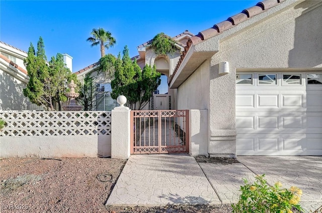 8052 Marbella Cir, Las Vegas, NV 89128 - view of front of property with stucco siding, a gate, a garage, and a tiled roof