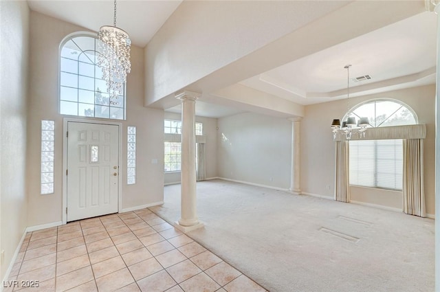 8052 Marbella Cir, Las Vegas, NV 89128 - foyer entrance with a chandelier, ornate columns, baseboards, and light colored carpet