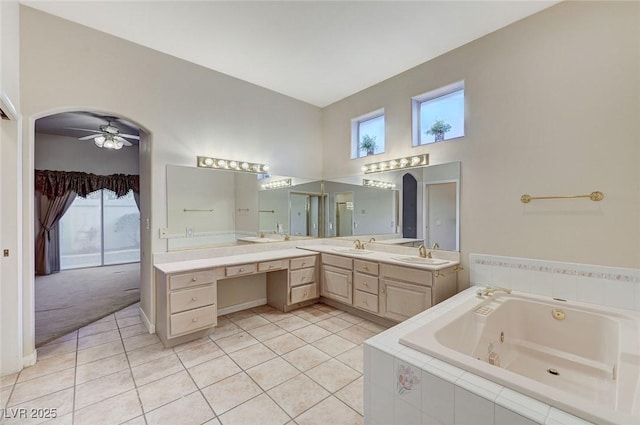 8052 Marbella Cir, Las Vegas, NV 89128 - bathroom with a tub with jets, vanity, tile patterned flooring, and ceiling fan